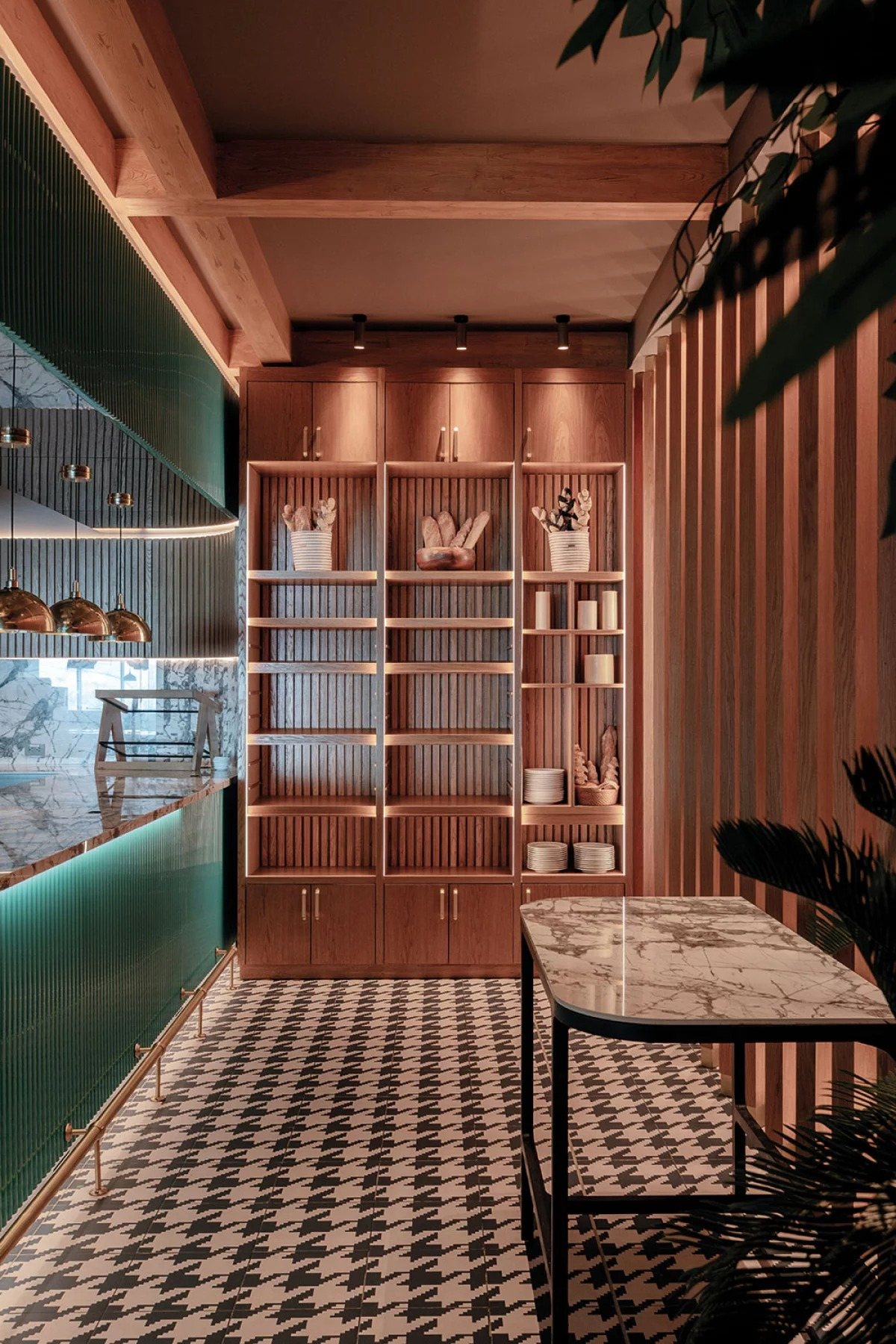 Bakery cafe with brass dome pendants and illuminated timber shelving