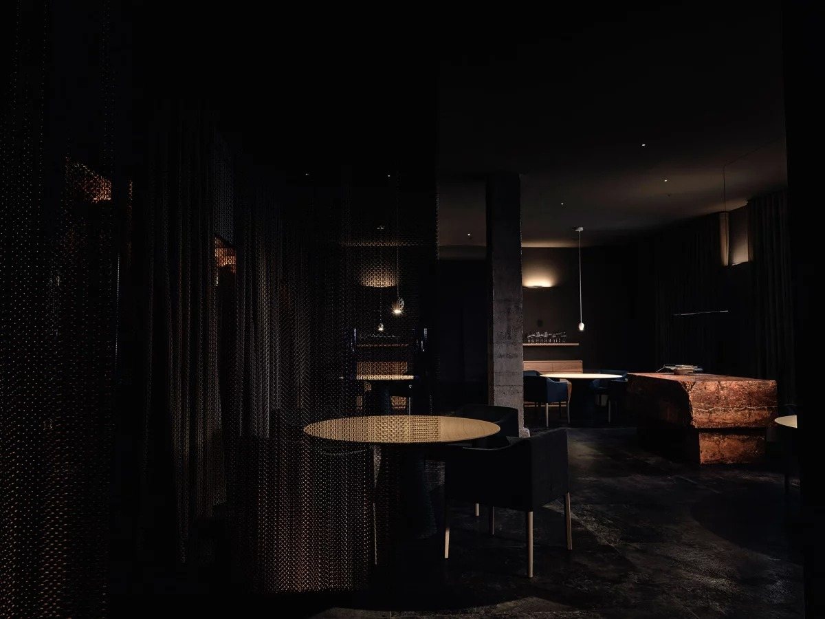 Fine dining restaurant with low-glare pendants and a copper-toned stone counter